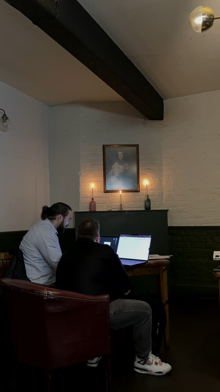 Two people building a flow together on a laptop in a quiet corner