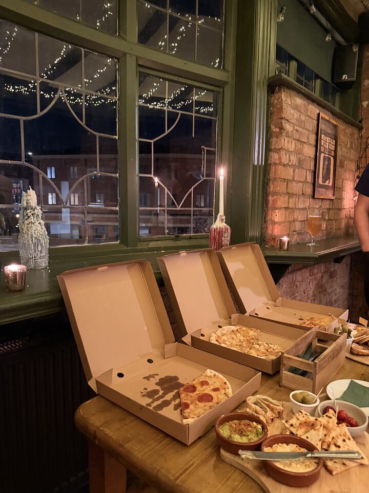 Pizza and sharing platters laid out by the window